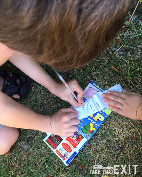 Signing the logbook at the geocache in Leavenworth, Washington (downtown)