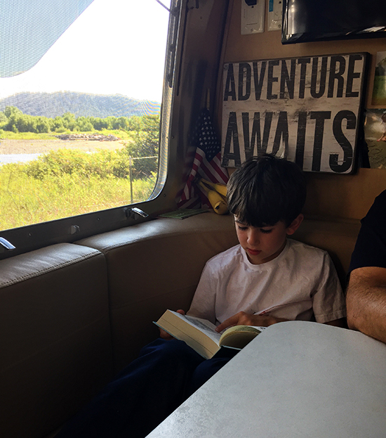 Reading-by-the-river-Montana